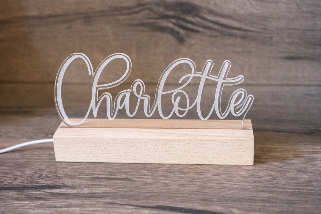 Personalisierte LED Namenslampe aus Acrylglas mit dem Namen Charlotte auf Holzsockel